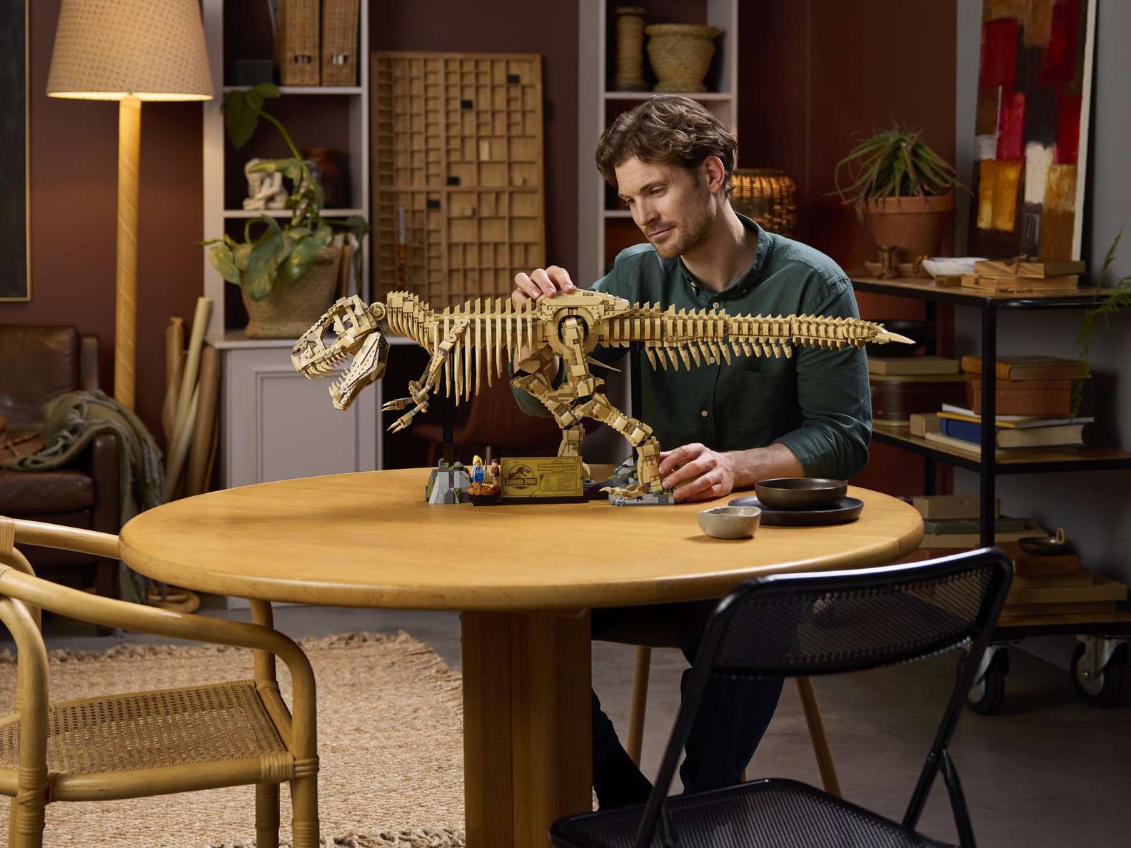 Detailed LEGO Jurassic Park T. rex dinosaur fossil model in tan, being admired by a man. Bricking Lebanon