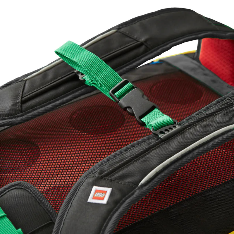 Close-up of a LEGO backpack with a green strap and red interior