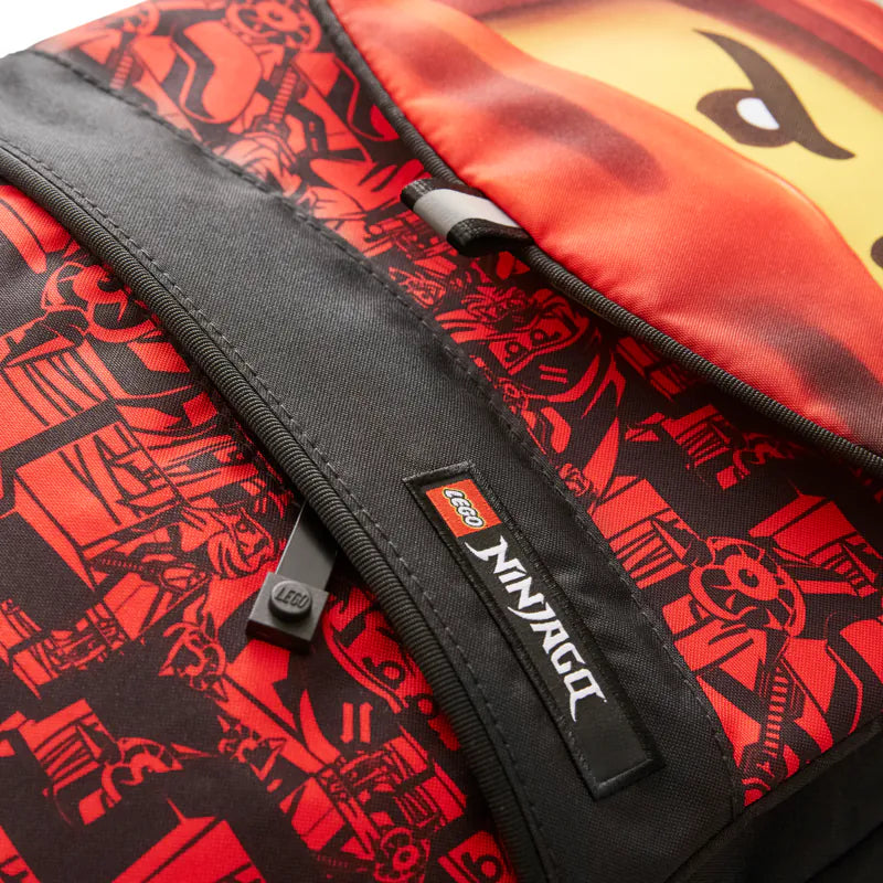 Close-up of a LEGO Ninjago backpack with red and black design and visible LEGO logo.