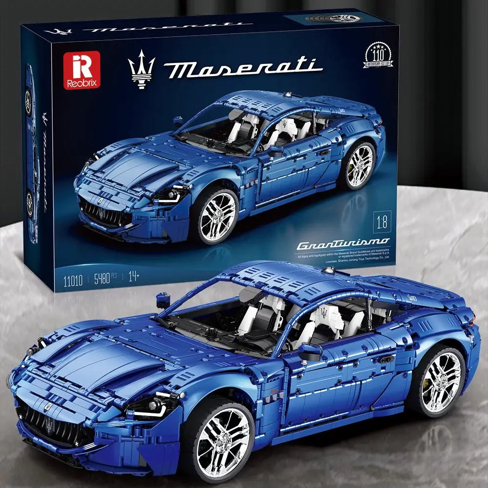 Blue Maserati model car toy with packaging on a gray surface