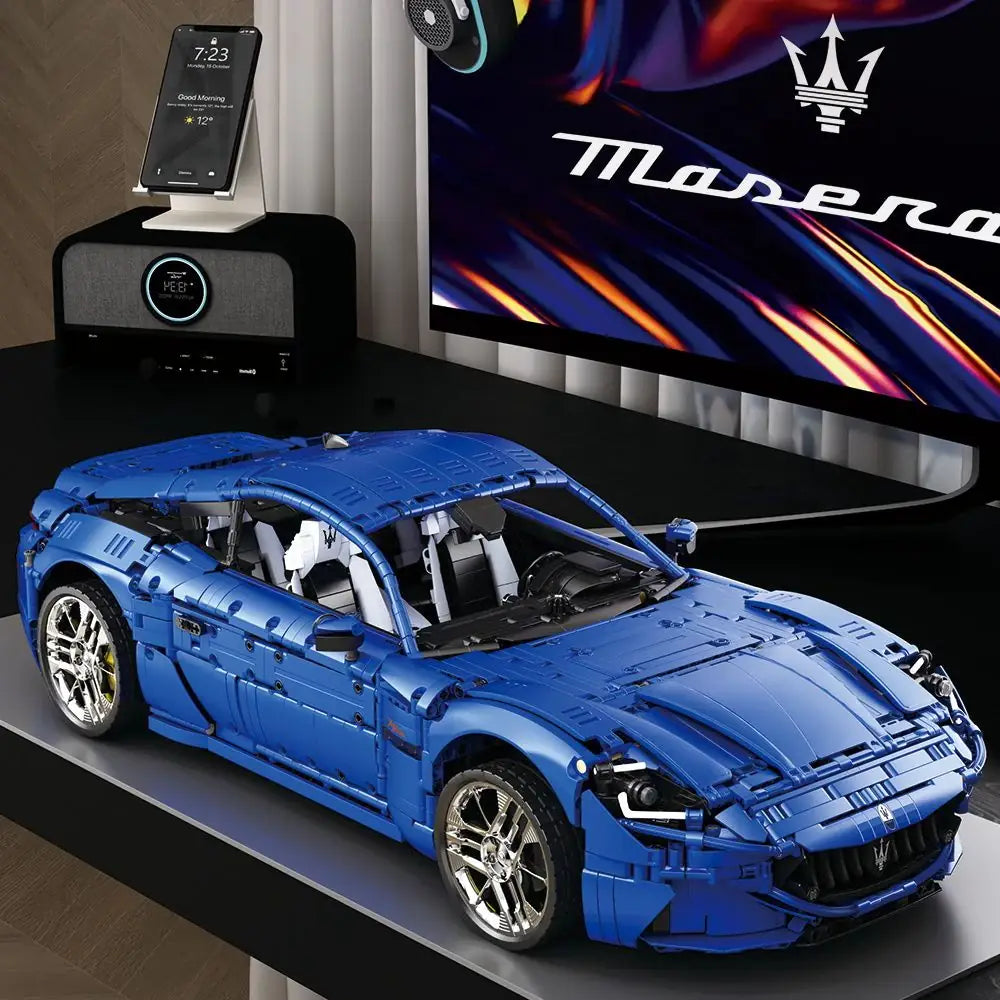 Blue model car on a table with a Maserati logo in the background